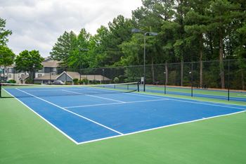 Lighted Tennis Court with Adjacent Sports Court